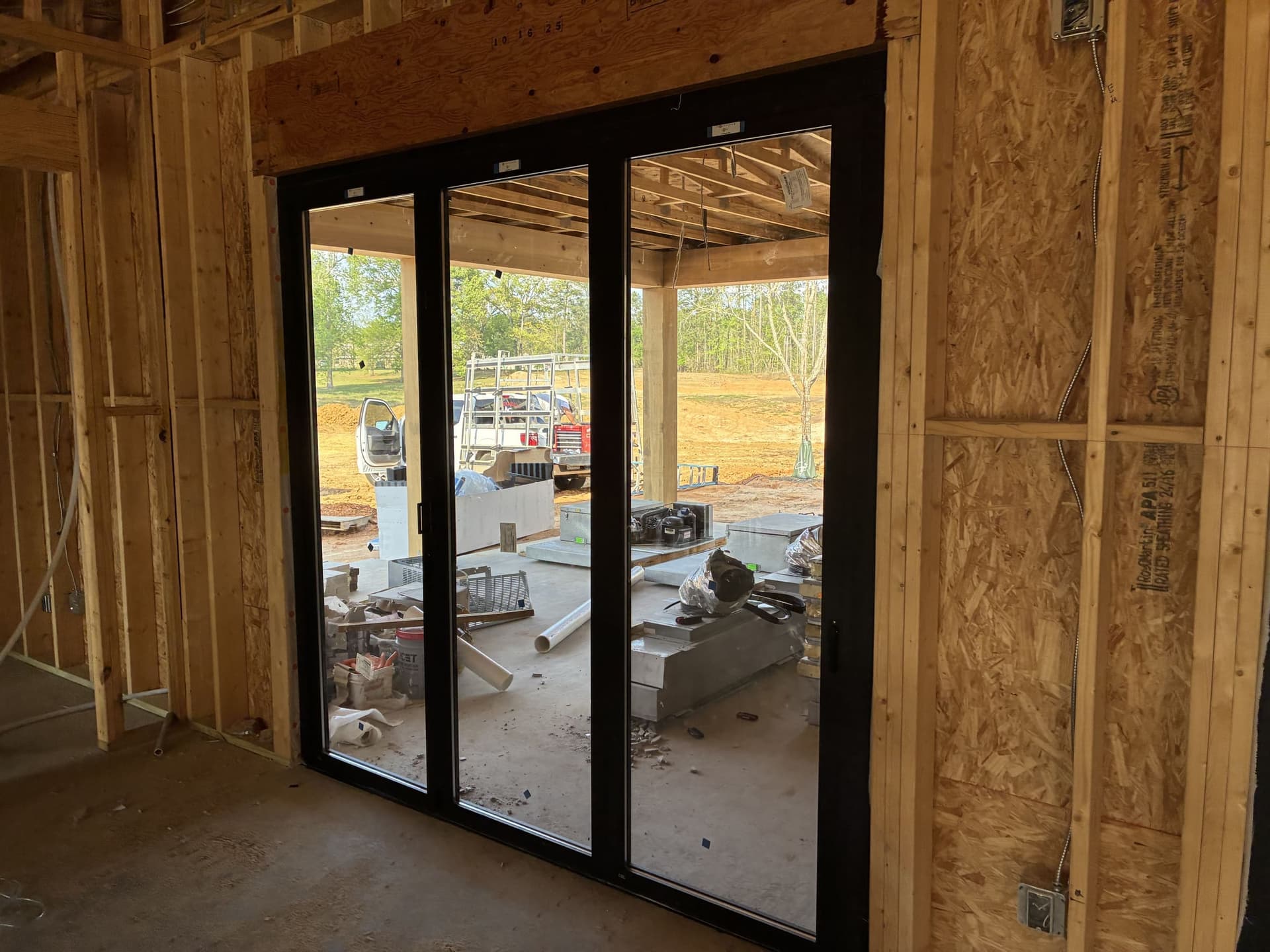 Three-panel sliding glass door installed in framed-out construction